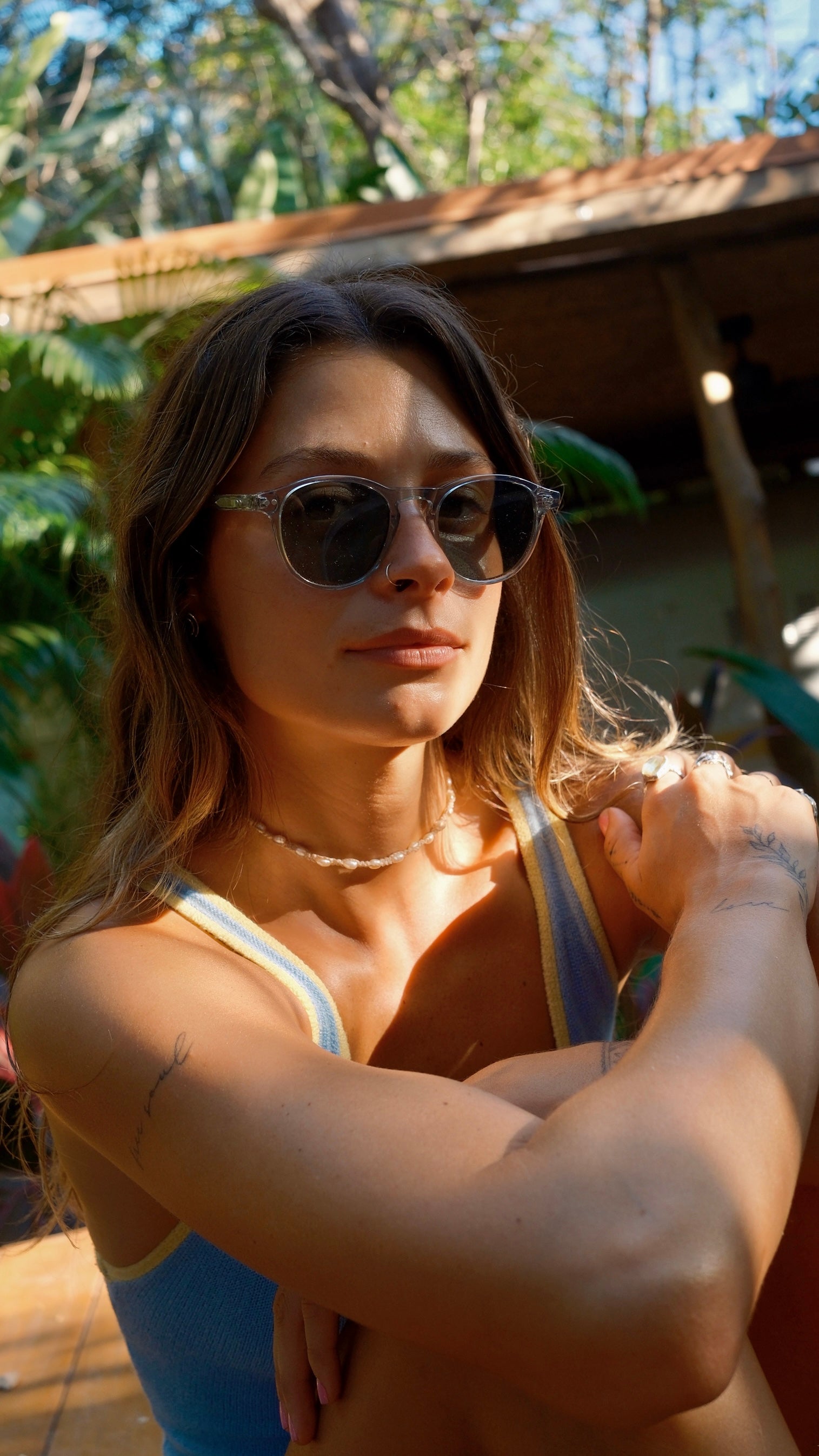 Woman wearing sunglasses with a natural outdoor background